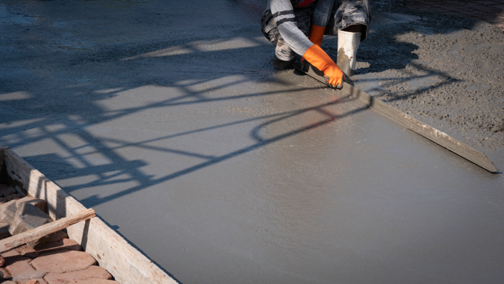asian-construction-worker-using-long-triangle-trowel-plastering-cement-floor-construction-site