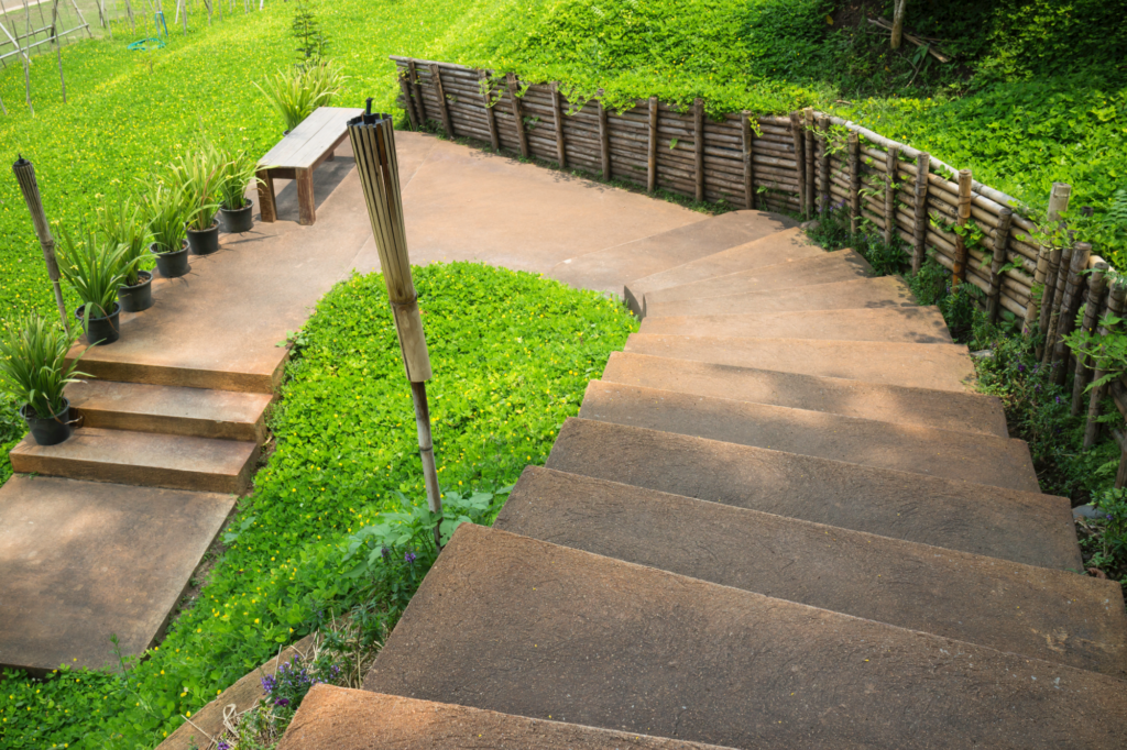 step-brown-stone-stairs-with-green-plant-beside-walk-way
